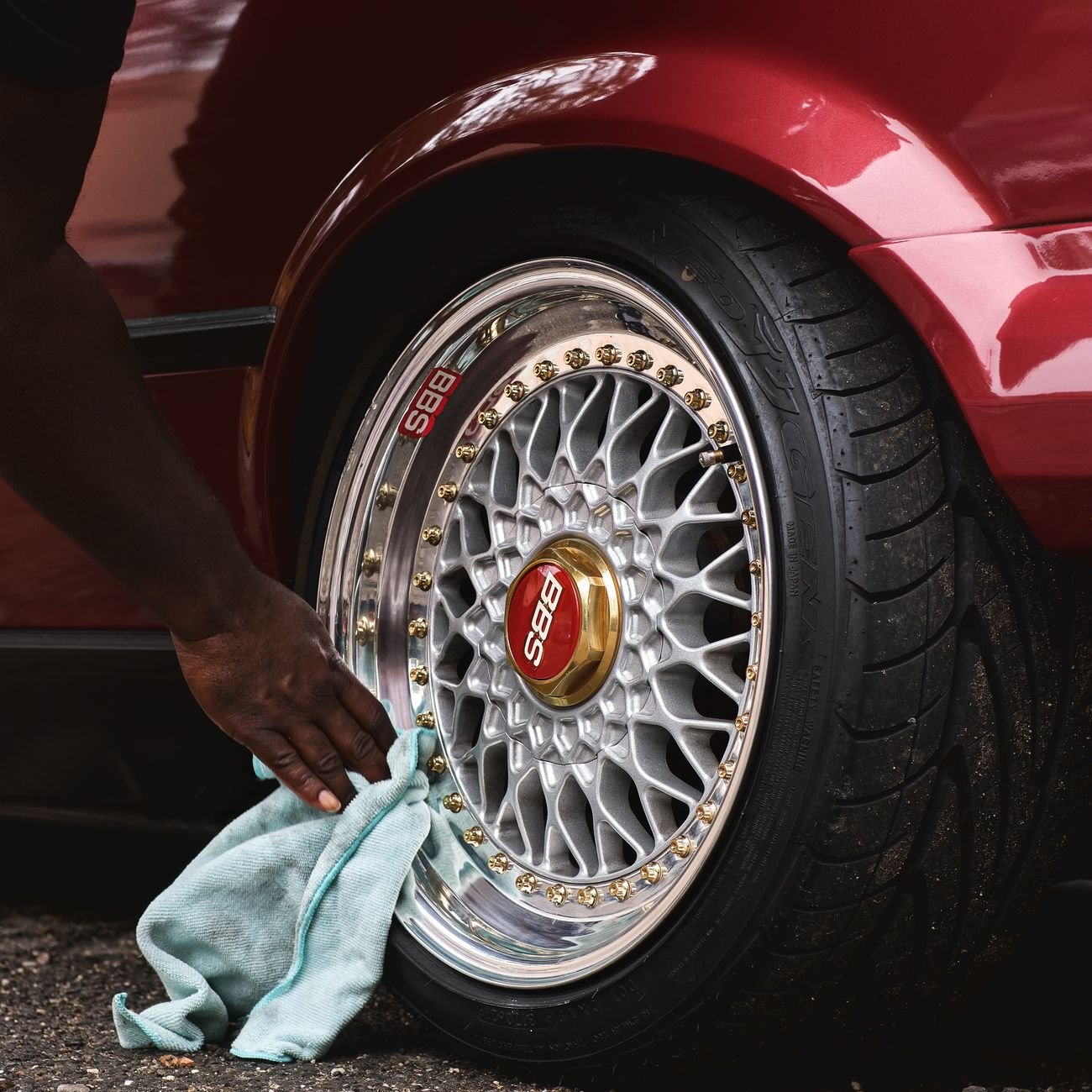 Person cleaning a car wheel rim — car detailers are a key Keppa trade segment